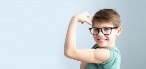 Image of a boy with a band aid on arm